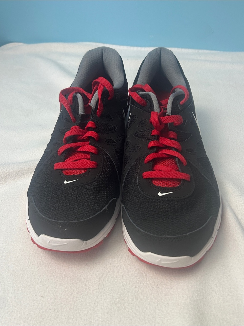 Nike Black Running Shoe with Red Laces and White Swoosh